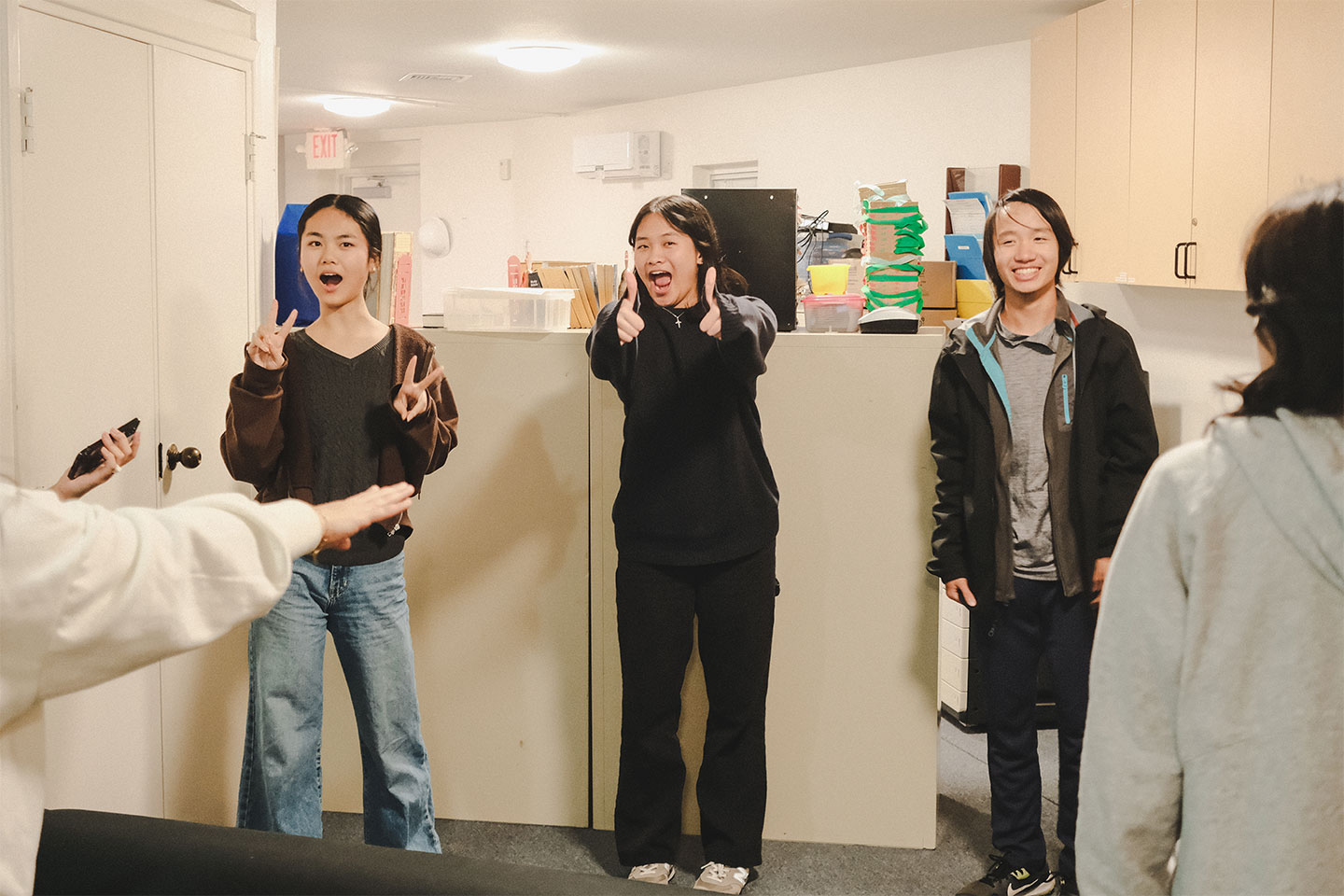 Three people smiling and being excited and shocked
