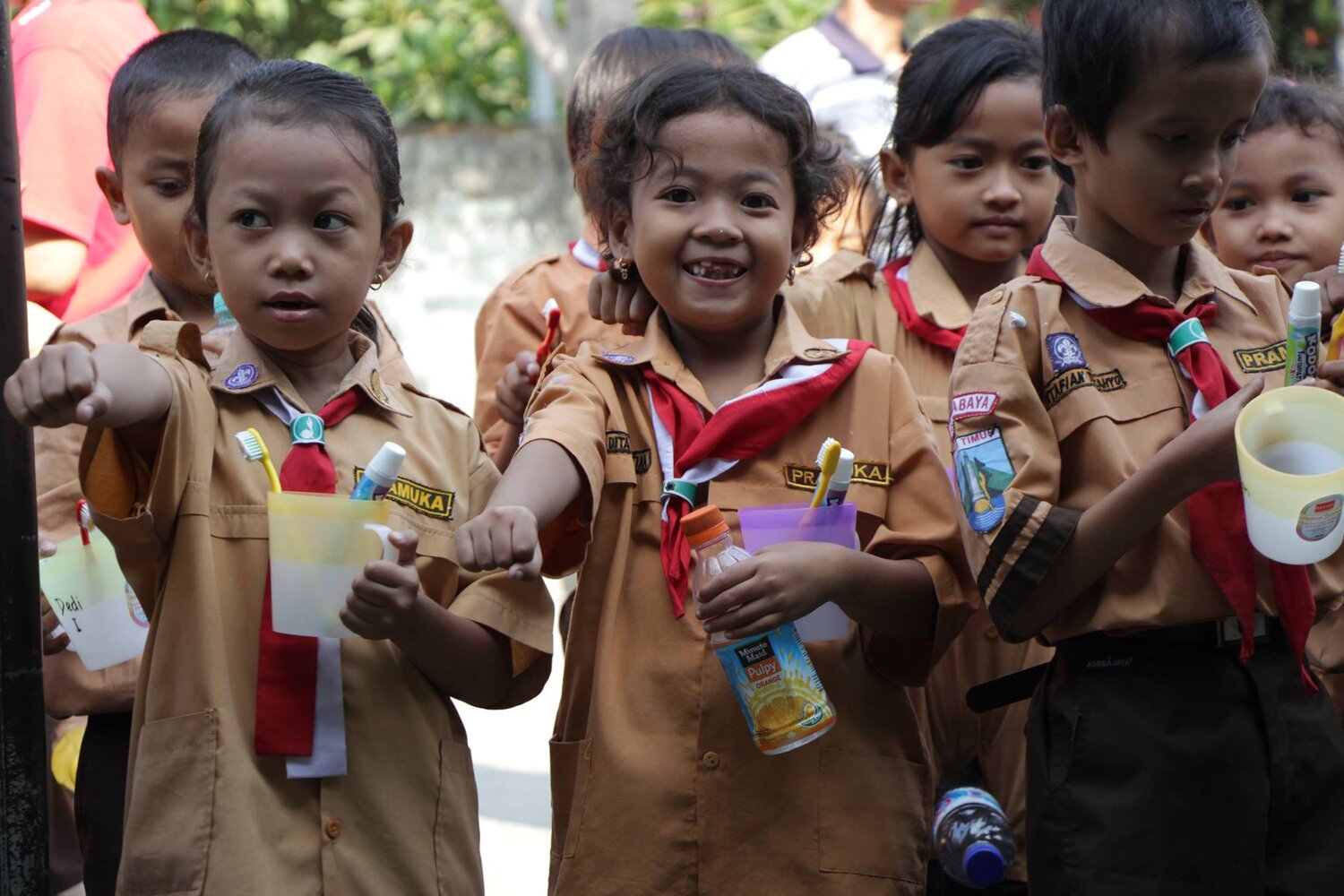 Four girl scouts holding up fist bump