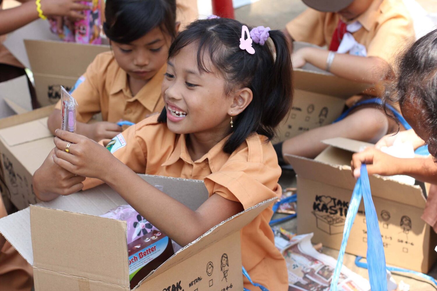 Happy kids opening up items from boxes