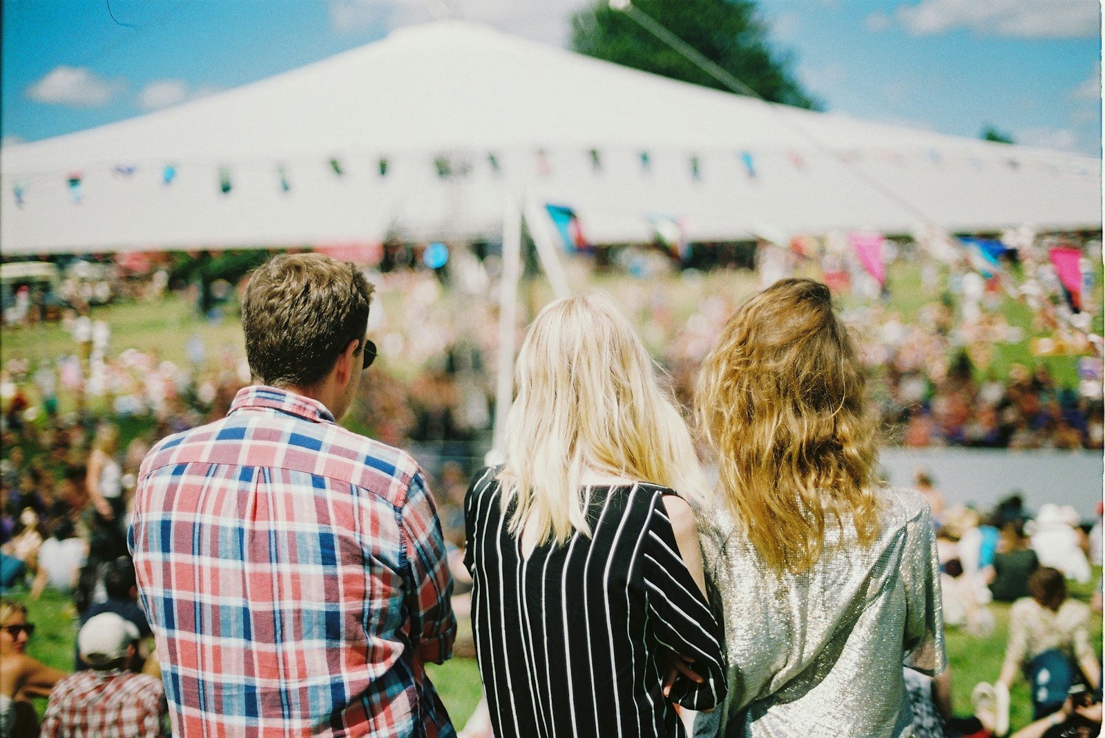 Festival guests walking through a summer fair