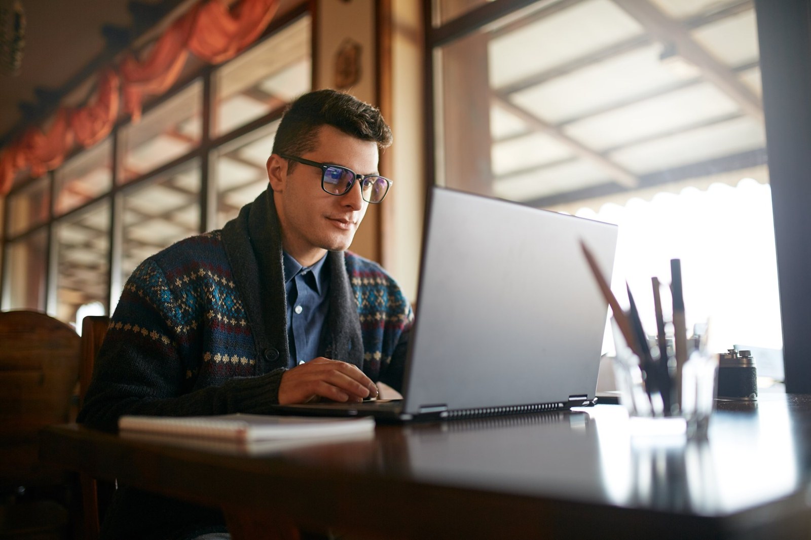 An event organizer working at a laptop