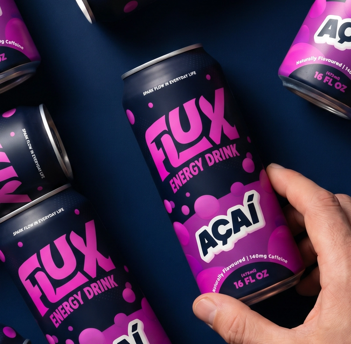 Image of multiple energy drink cans laid out on a dark table. A hand reaches for the one in the middle