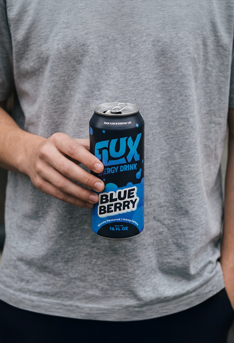 Image of a guy standing outside holding a Flux energy drink can.