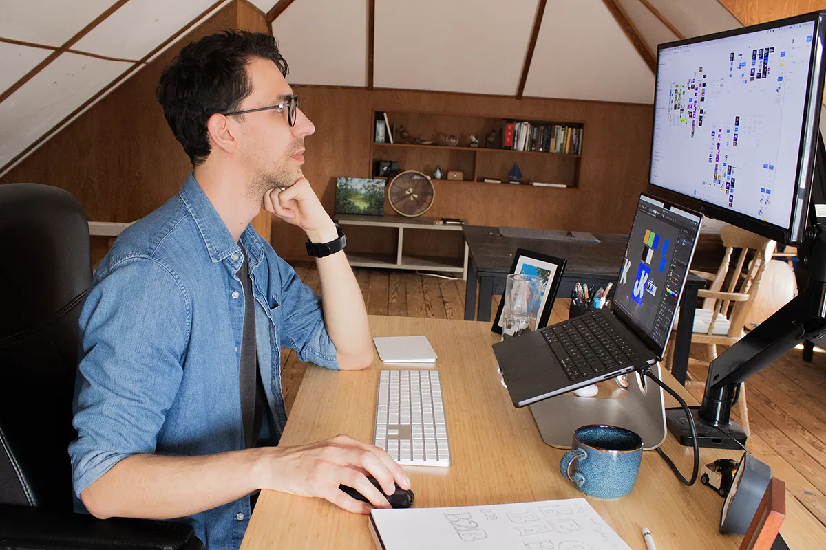 Picture of Jeremy working on his computer in his studio.