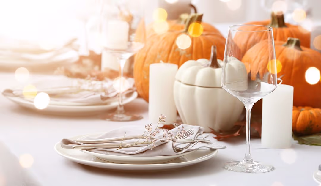 Table setting with pumpkins and white plates