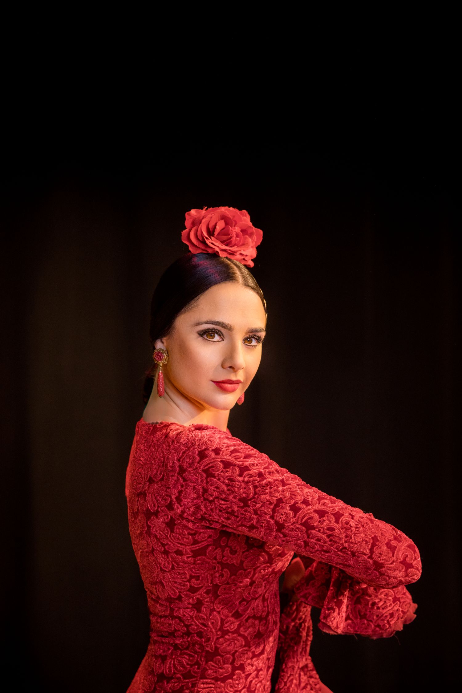 La Emi Flamenco dancer in red dress with flower in hair