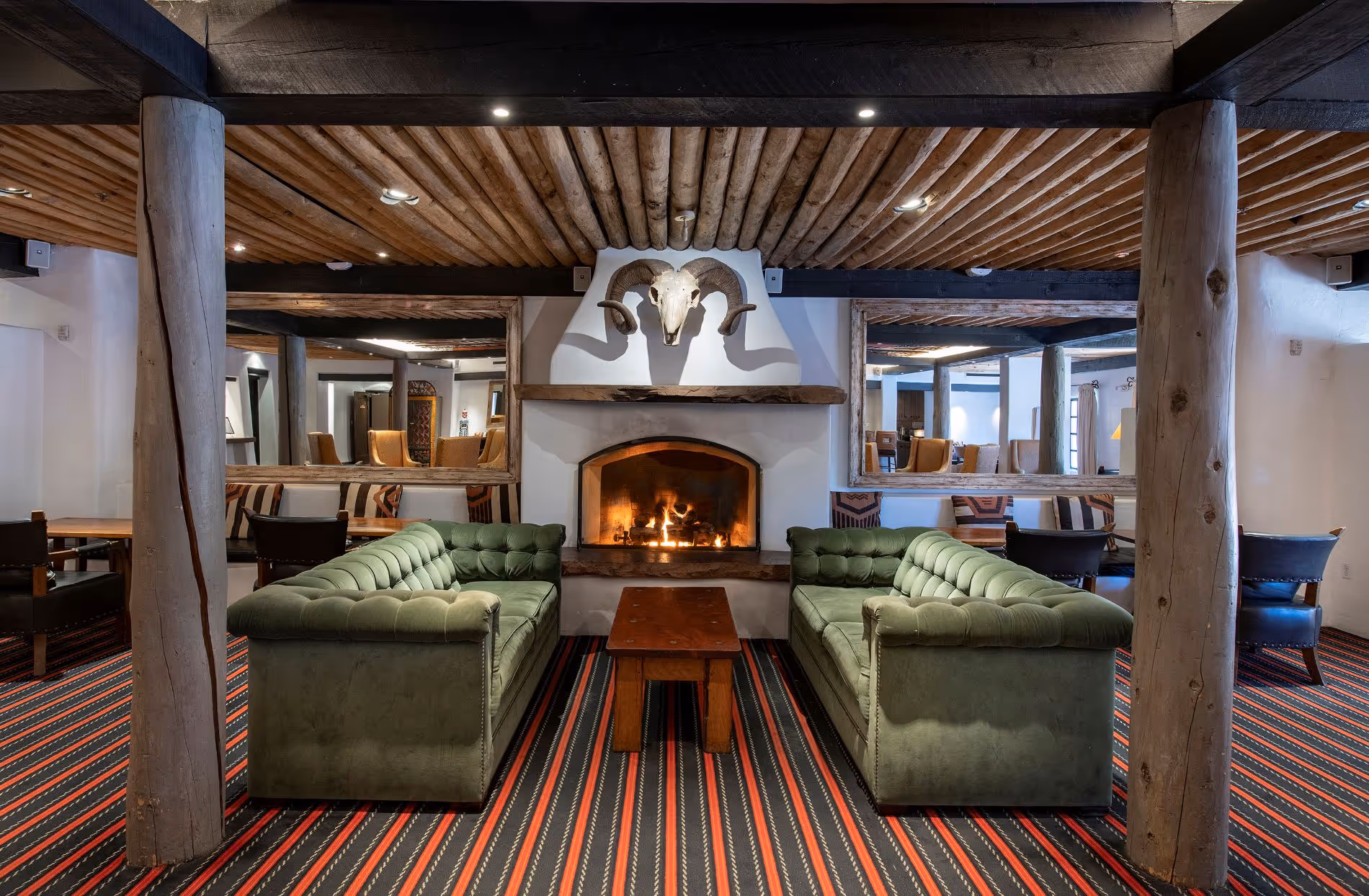 The Living Room with fireplace and green couches