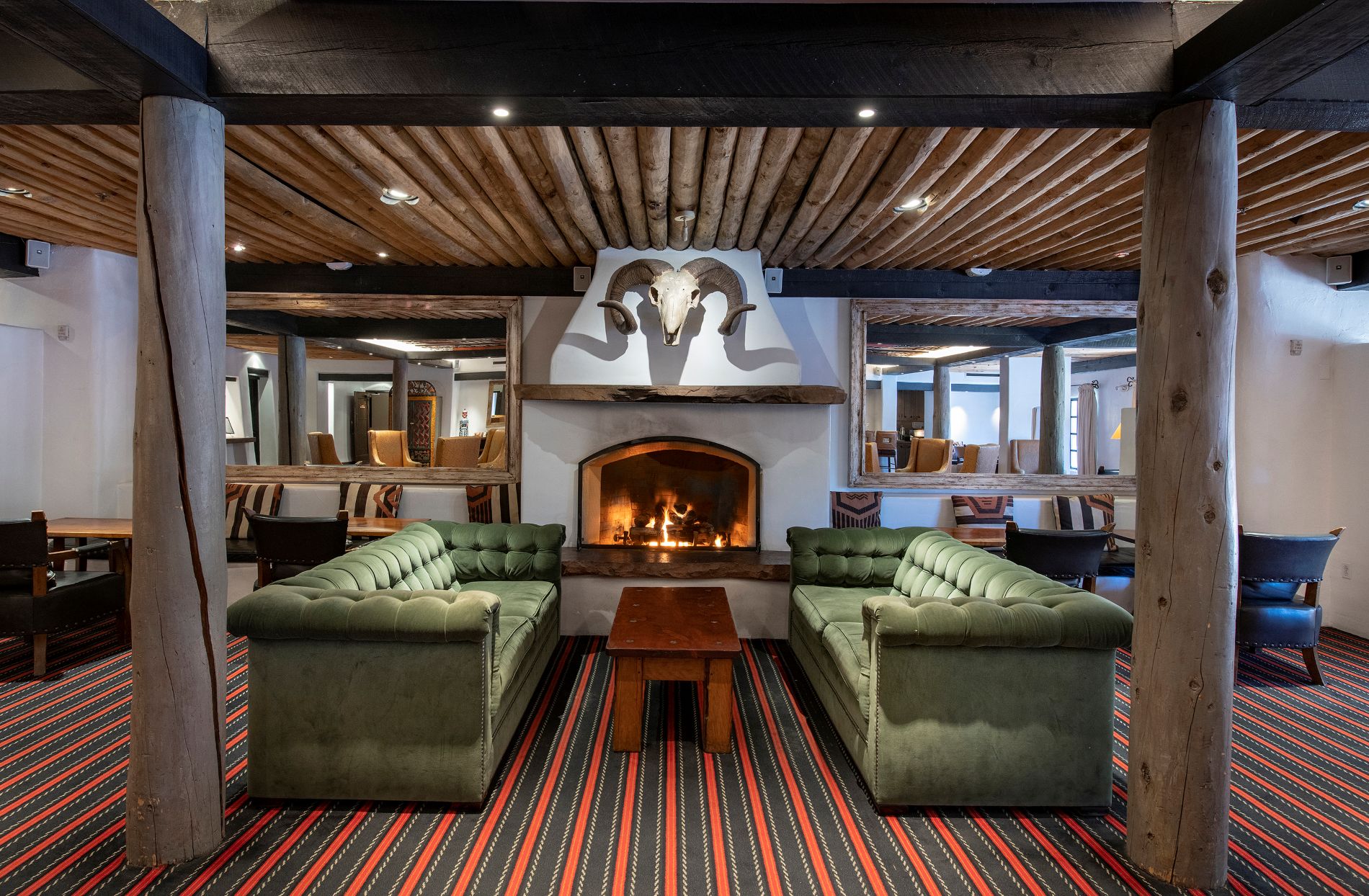 The Living Room with fireplace and green couches