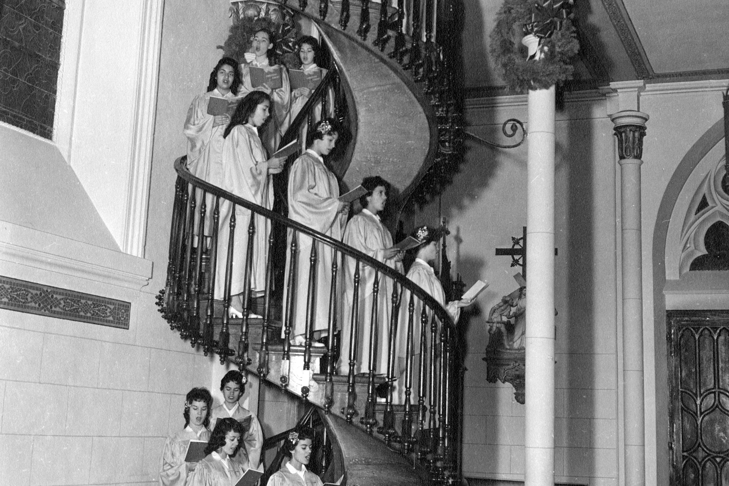 Photographer: Charles E. Lord / Lord Studio, Title: Girls choir on spiral staircase, Loretto Academy Chapel, Santa Fe, New Mexico, Date: ca. 1960, Courtesy Palace of the Governors Photo Archives (NMHM/DCA), Negative Number 014722