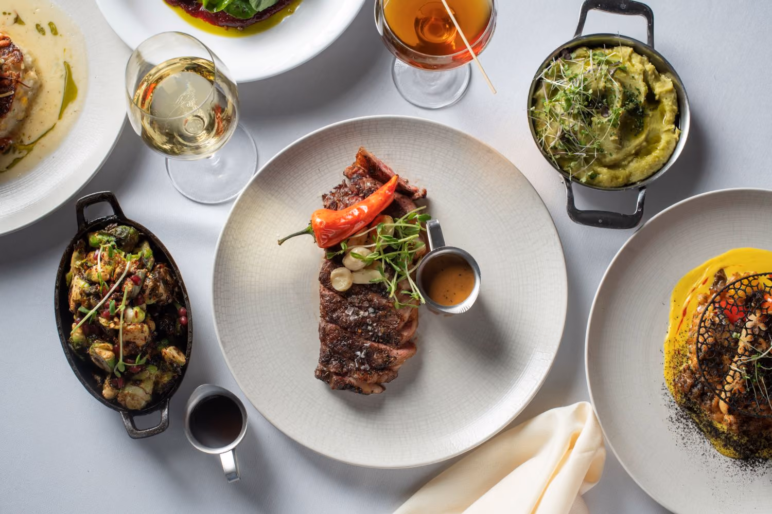 various plates with different dishes and some sides