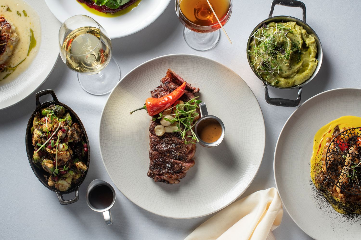 various plates with different dishes and some sides