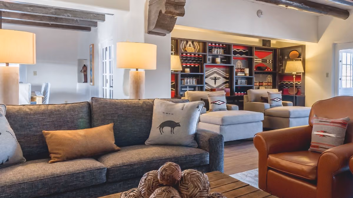 Living room of Penthouse suite with various couches and chairs with red, black and gray Southwestern accents