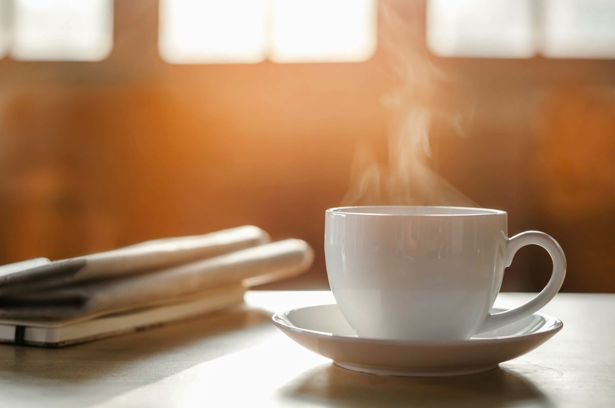 Latte in white cup with steam coming up from it