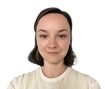 Portrait of a young woman with short brown hair wearing a beige sweater and white shirt, smiling slightly.