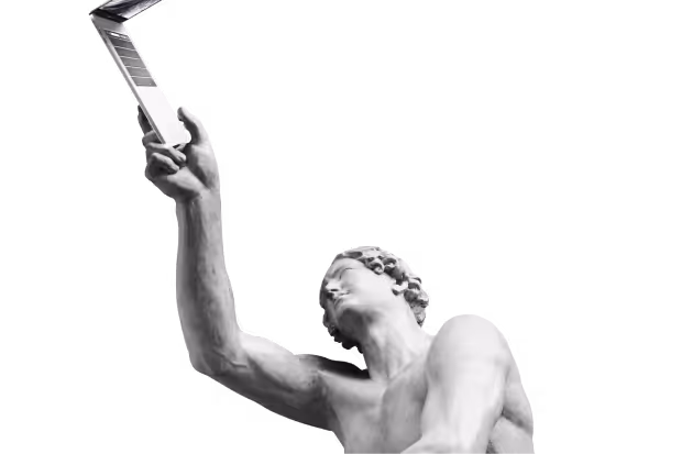 Classical statue of a man holding a modern laptop up in his right hand.