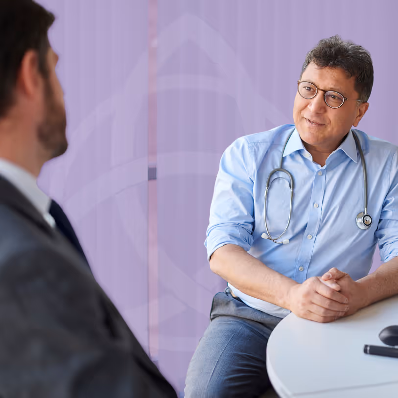 A consultant cardiologist speaking with a patient during a cardiology screening consultation at TAC Healthcare.