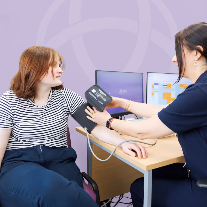 A nurse taking a patient’s blood pressure during a consultation at TAC Healthcare