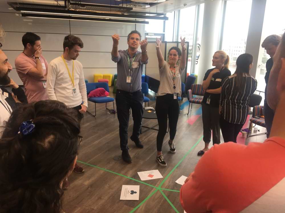 Team gathered round activity on the floor