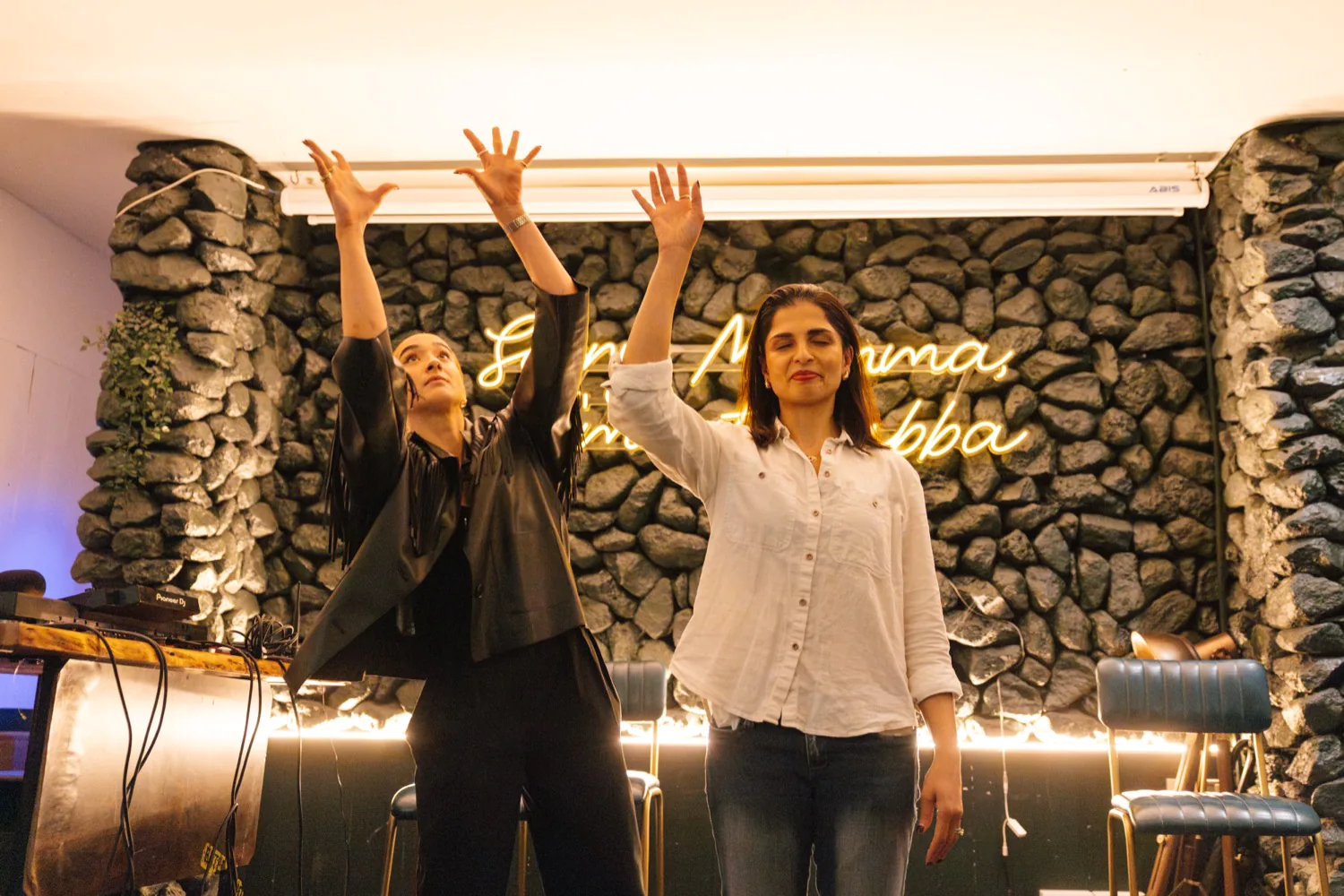 Sonia Benito magician on stage with guest hands in air in dynamic movement - Adam Kang