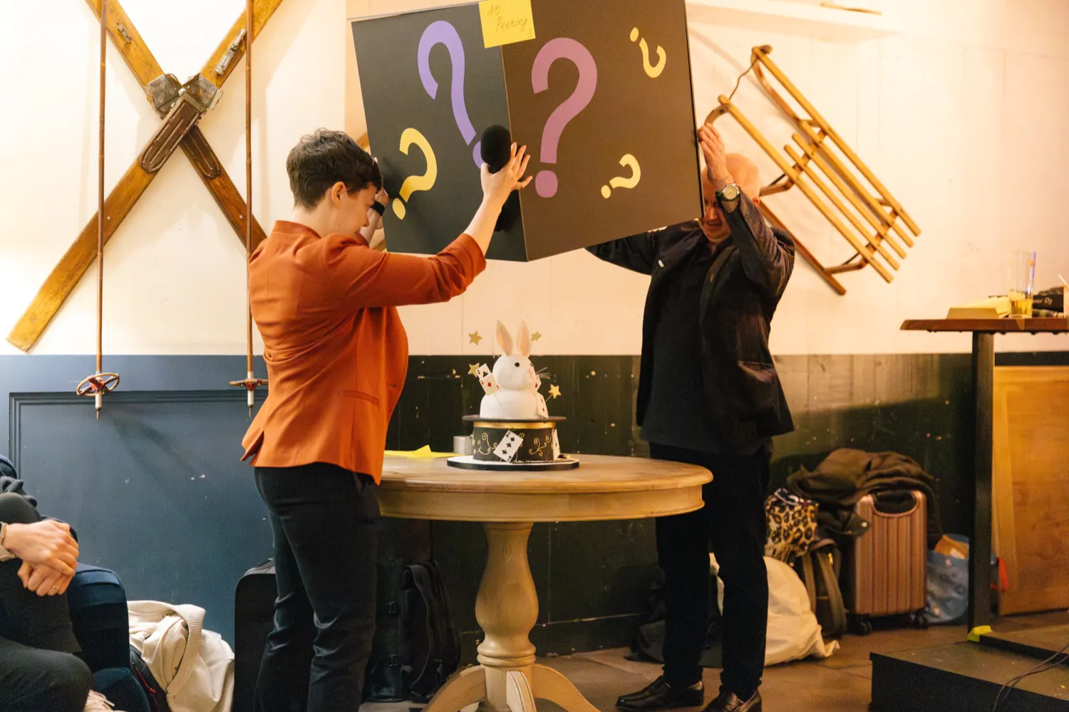 A cake shaped like a rabbit in a hat is revealed at abracademy's birthday party