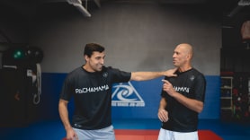 2 man practicing jiu jitsu.