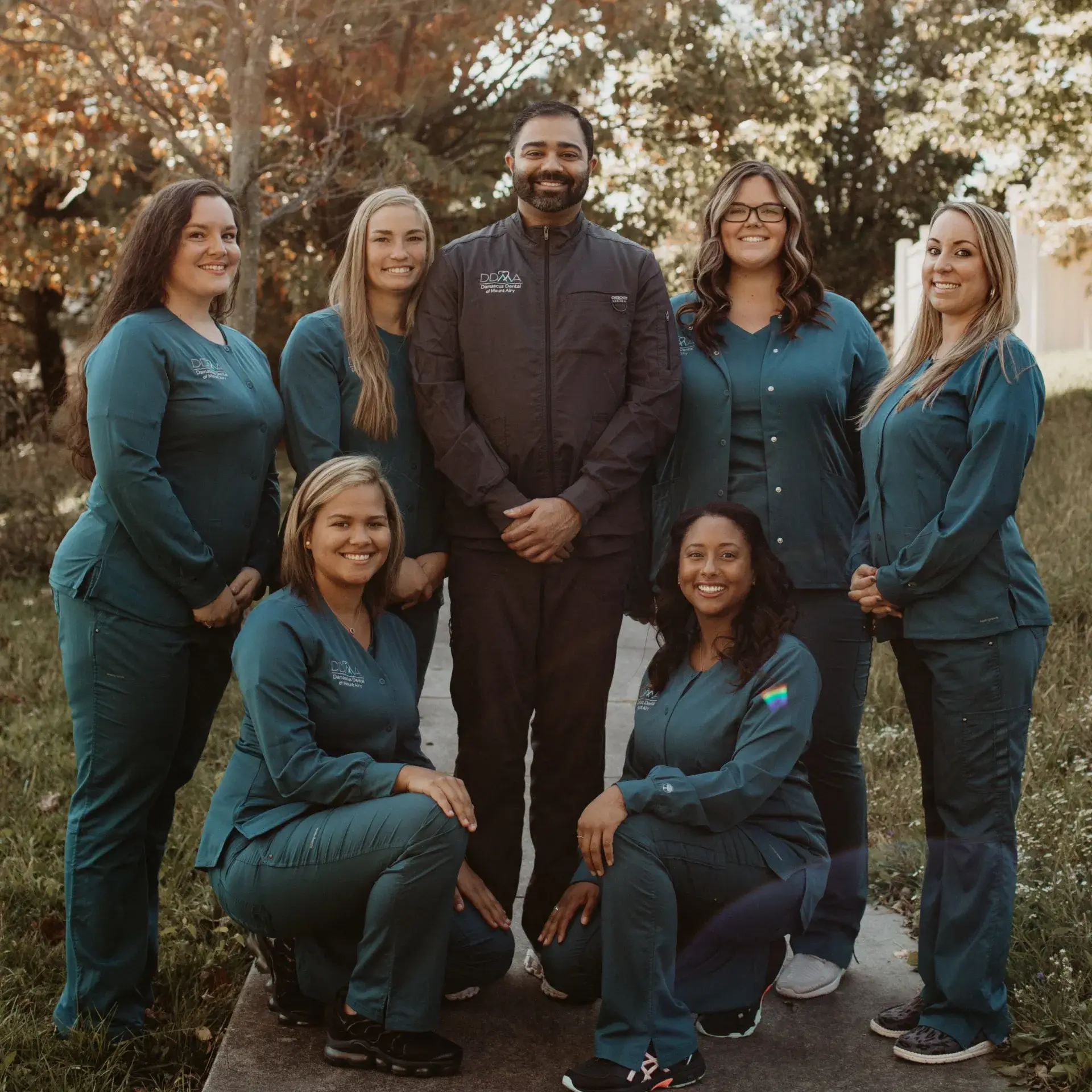 A group of people in scrubs posing for a picture.