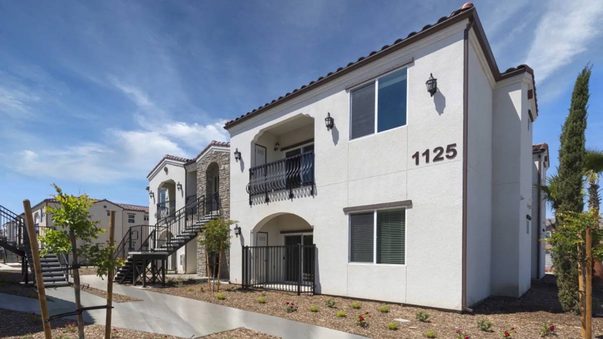 Image of a two story white apartment building in Visalia, California.