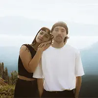 Couple embraces with stunning Rocky Mountain views during their Banff adventure shoot at sunset