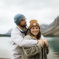 Happy couple by turquoise alpine lake in Lake Louise