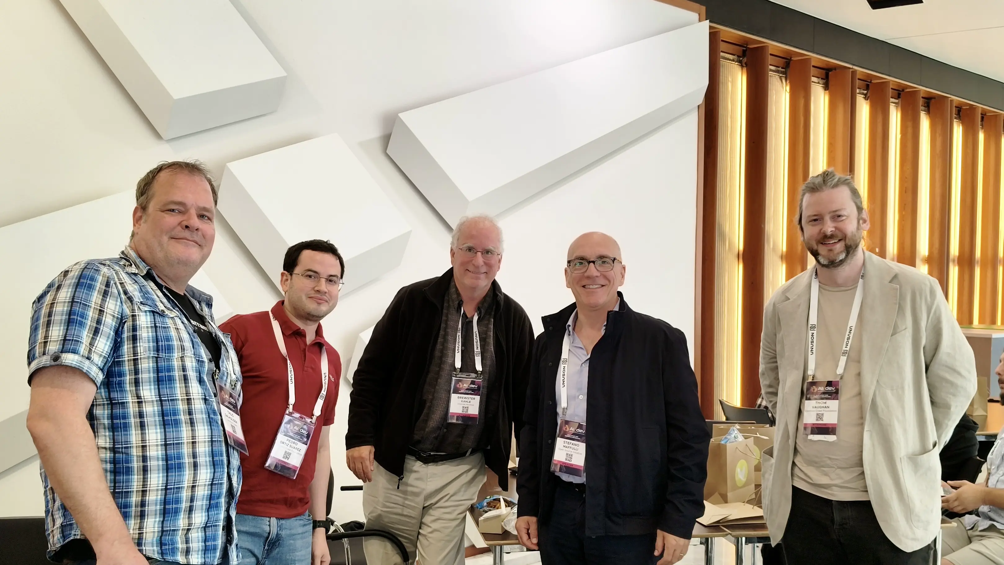 A photo with (left-to-right) Thijs Dalhuijsen, Pedro Ortiz Suarez, Brewster Kahle, Stefano Maffuli, Thom Vaughan at lunch with Brewster and Stefano on day one of AI_dev