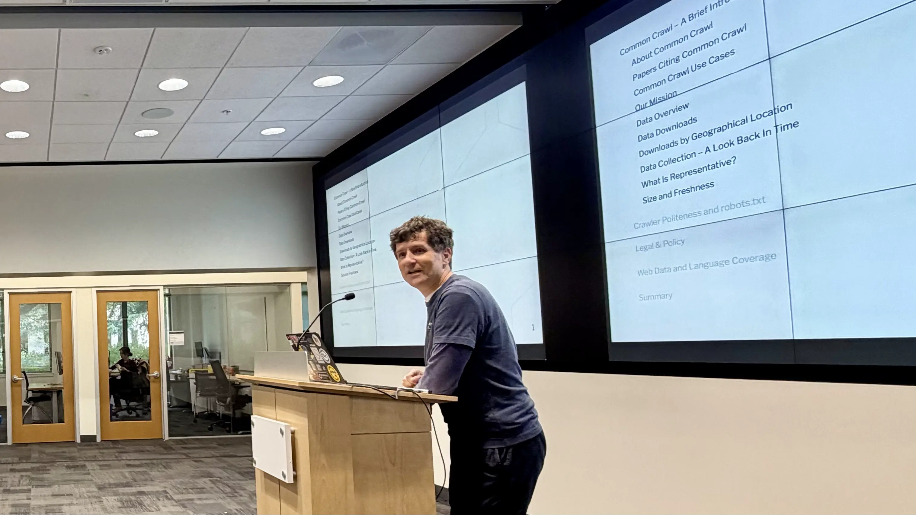 A photograph of Sebastian Nagel presenting at Stanford HAI