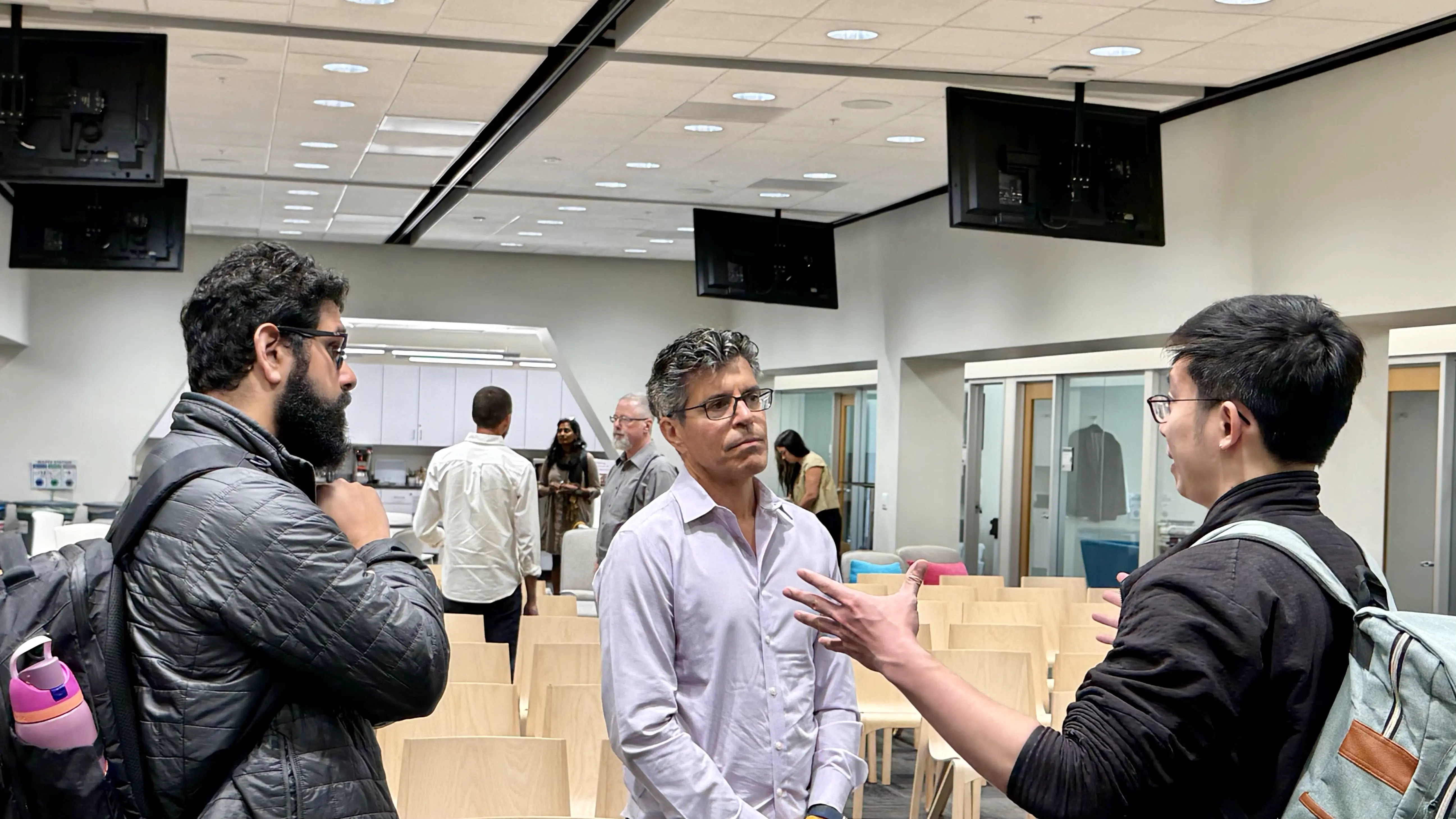 A photograph of Sammy Sidhu and Desmond Cheong from Eventual talking with our chairman Gil Elbaz