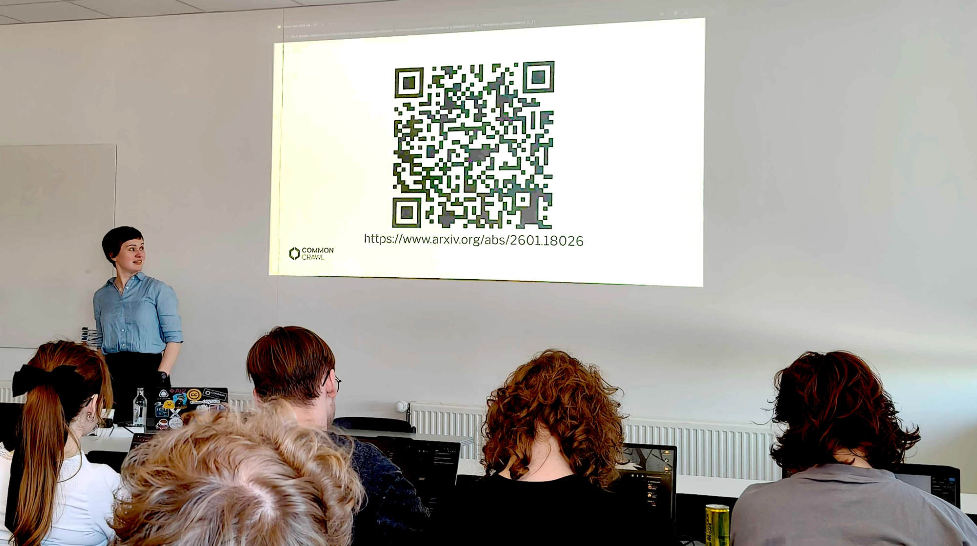 A photograph of Laurie Burchell presenting CommonLID at Howest