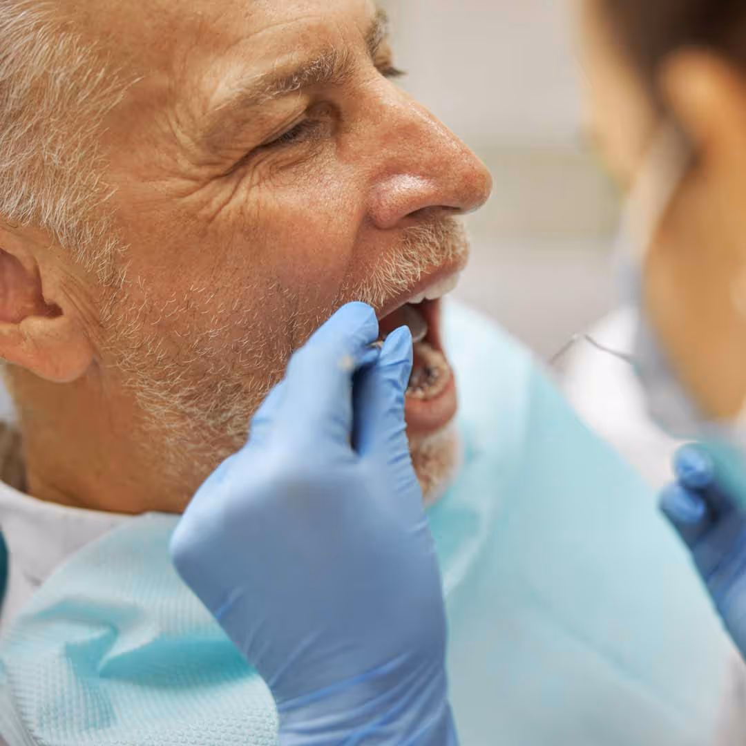 Older gentleman getting a tooth extraction