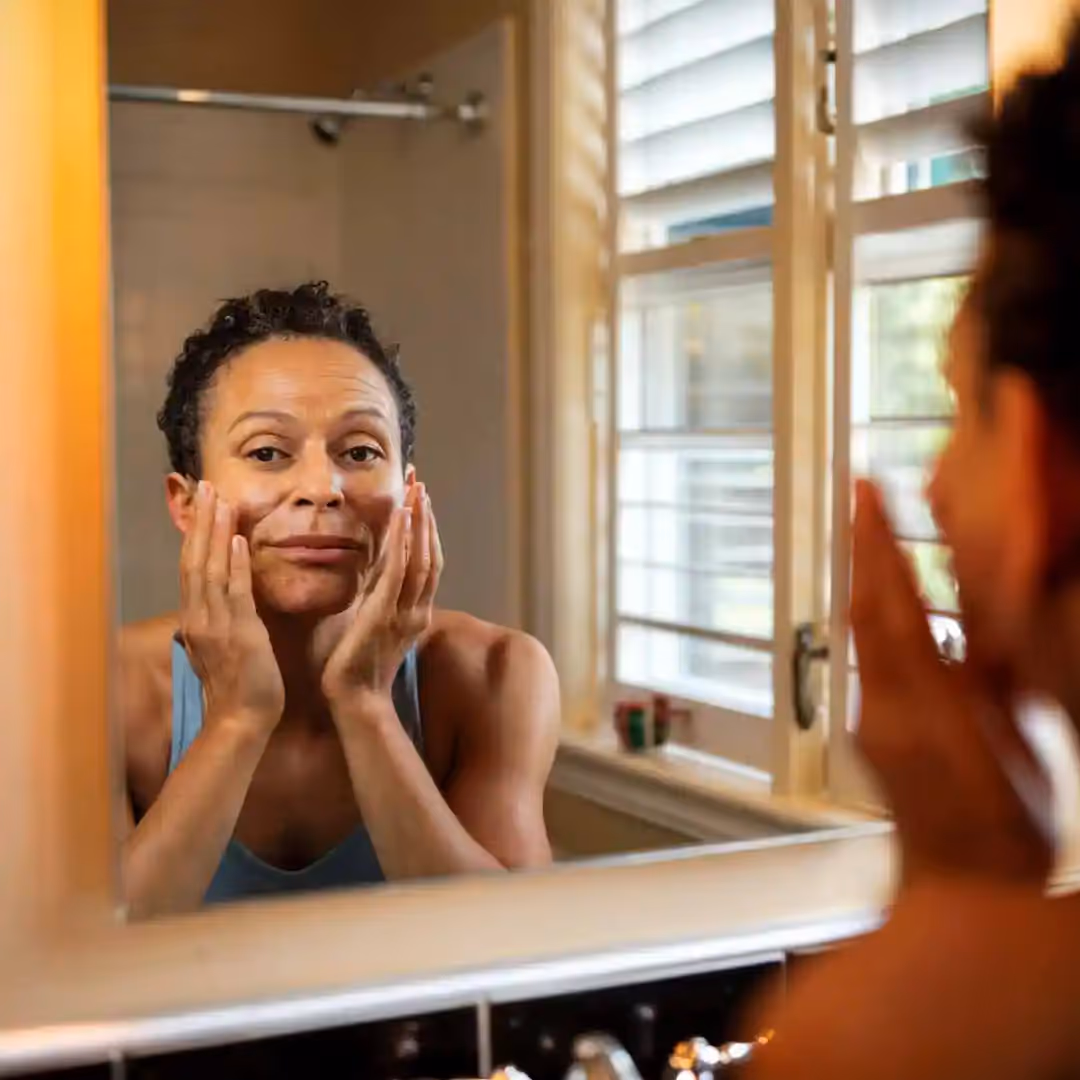 A lady doing facial exercises to help facial muscle structure.