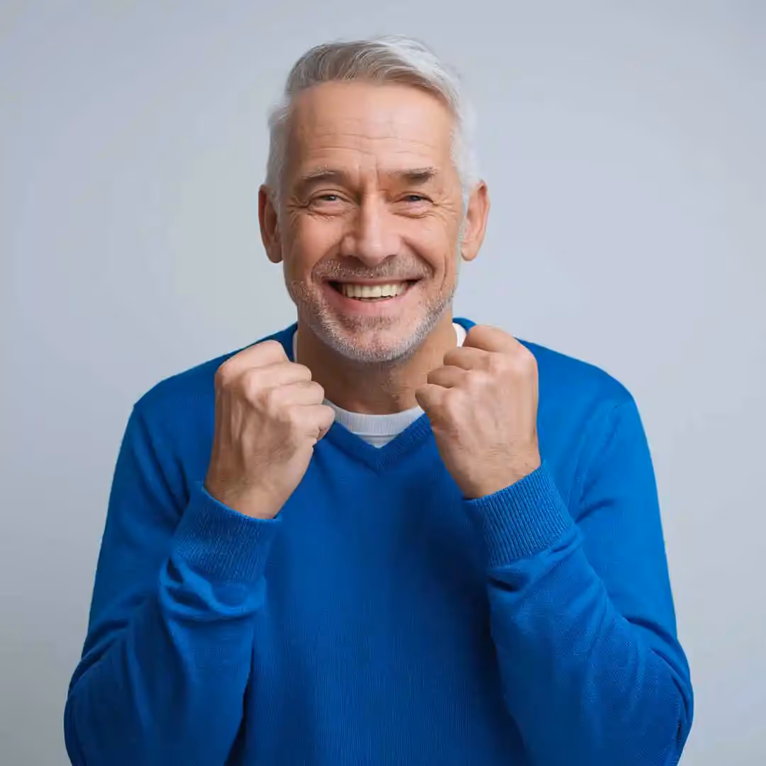 Older gentlemen excited to have his new smile with his new dentures