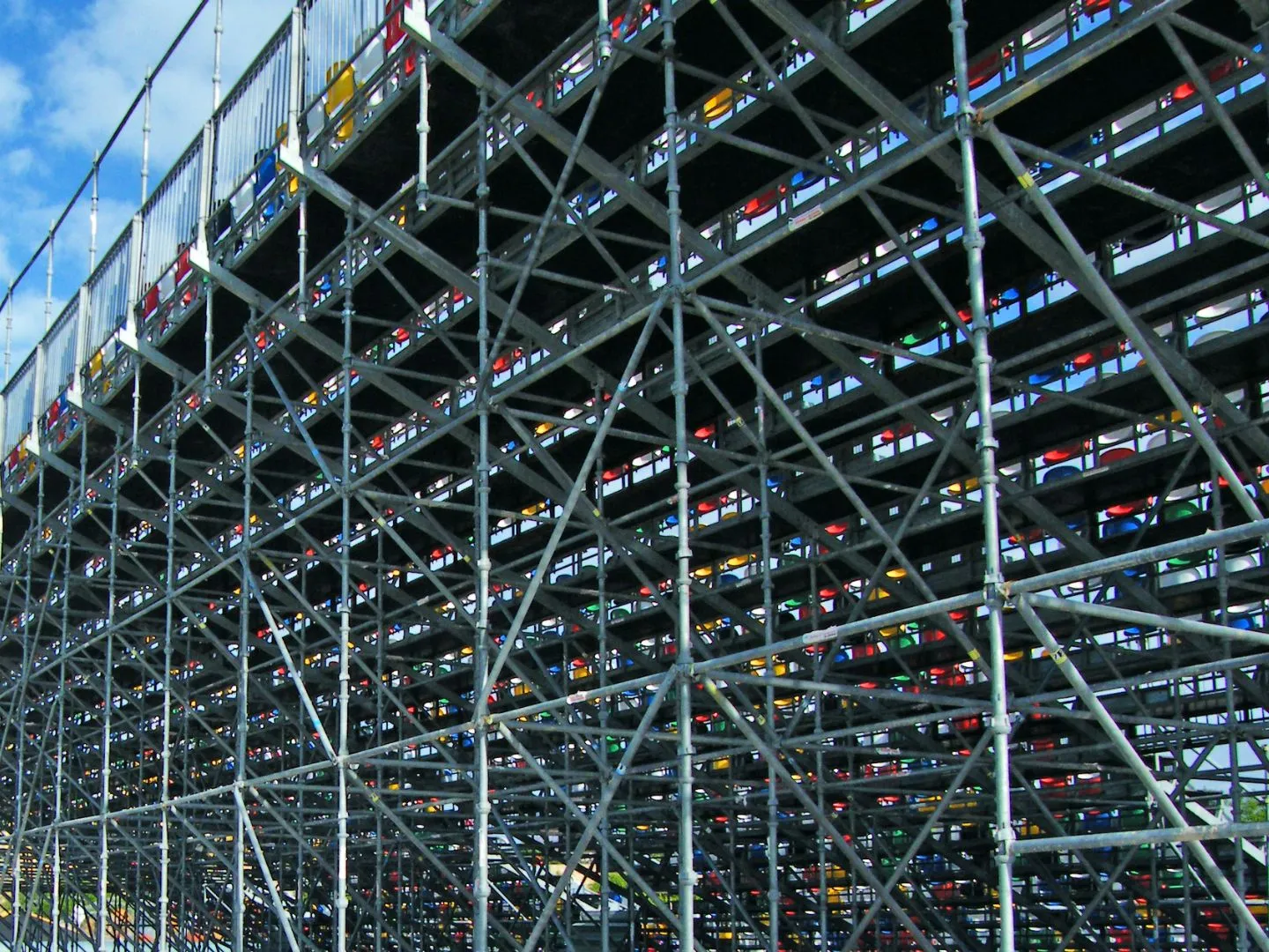 A row of scaffoldings on a building under a blue sky.