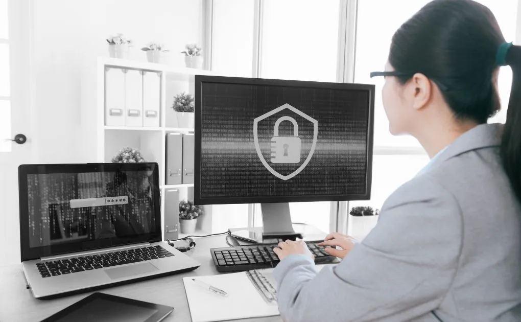 A woman sitting at a desk in front of a computer.