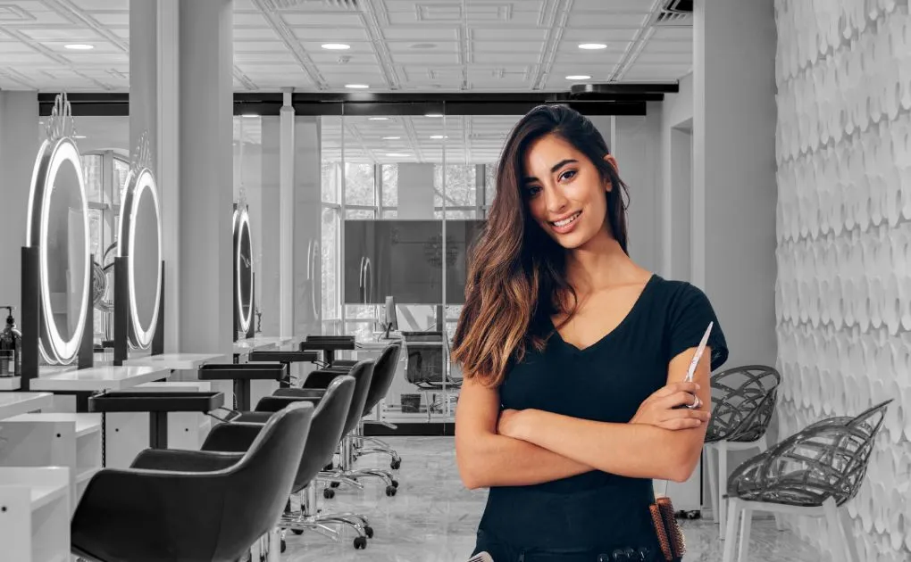 A woman standing in front of a row of chairs.