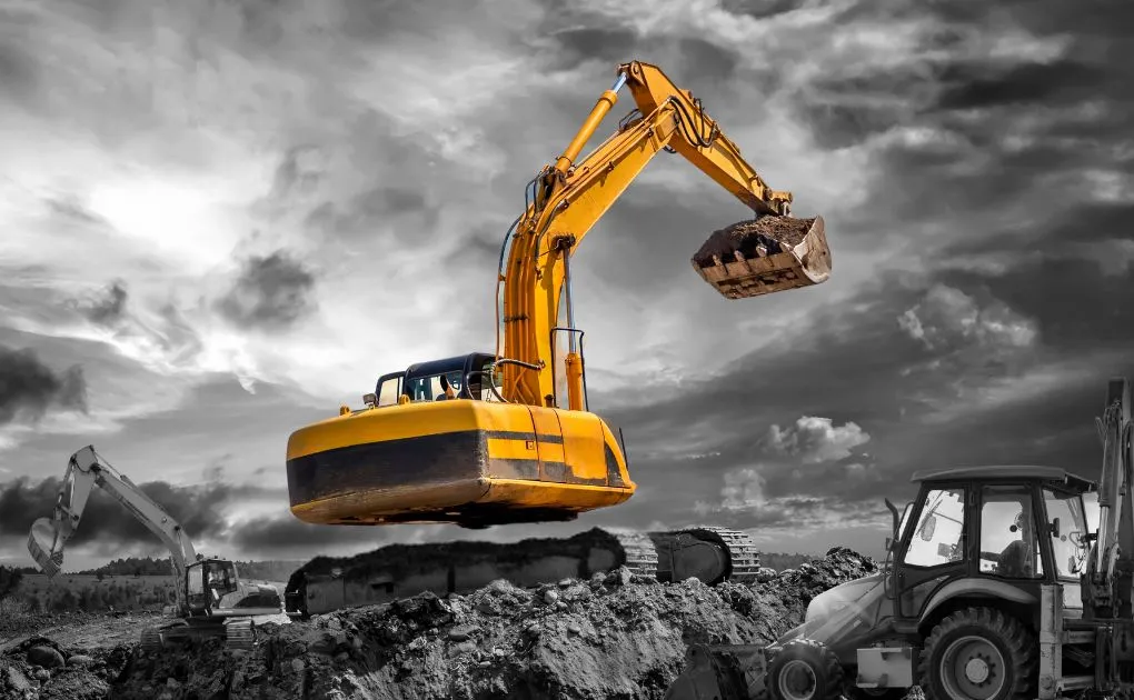 A bulldozer and a bulldozer in a black and white photo.