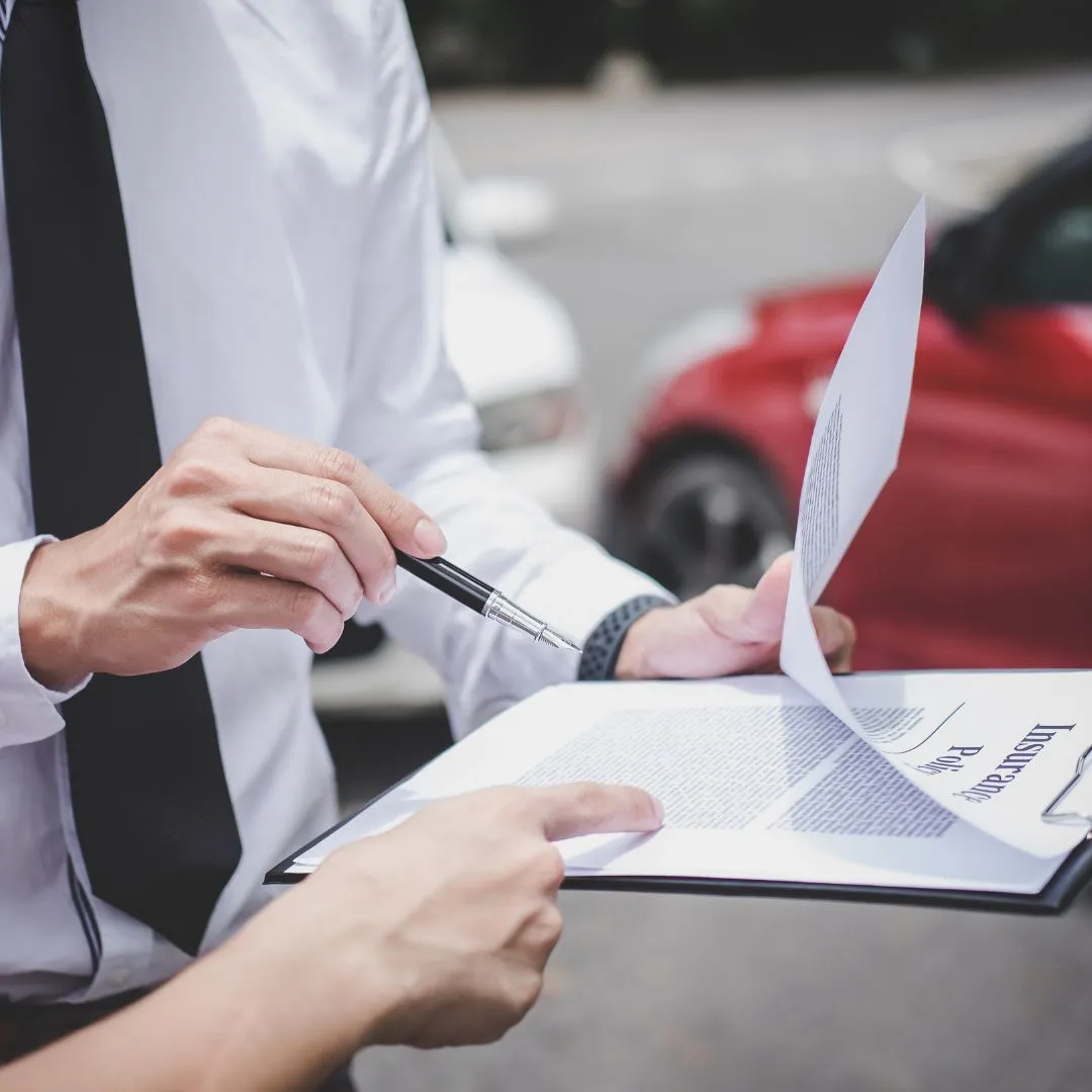 A man holding a piece of paper and a pen.