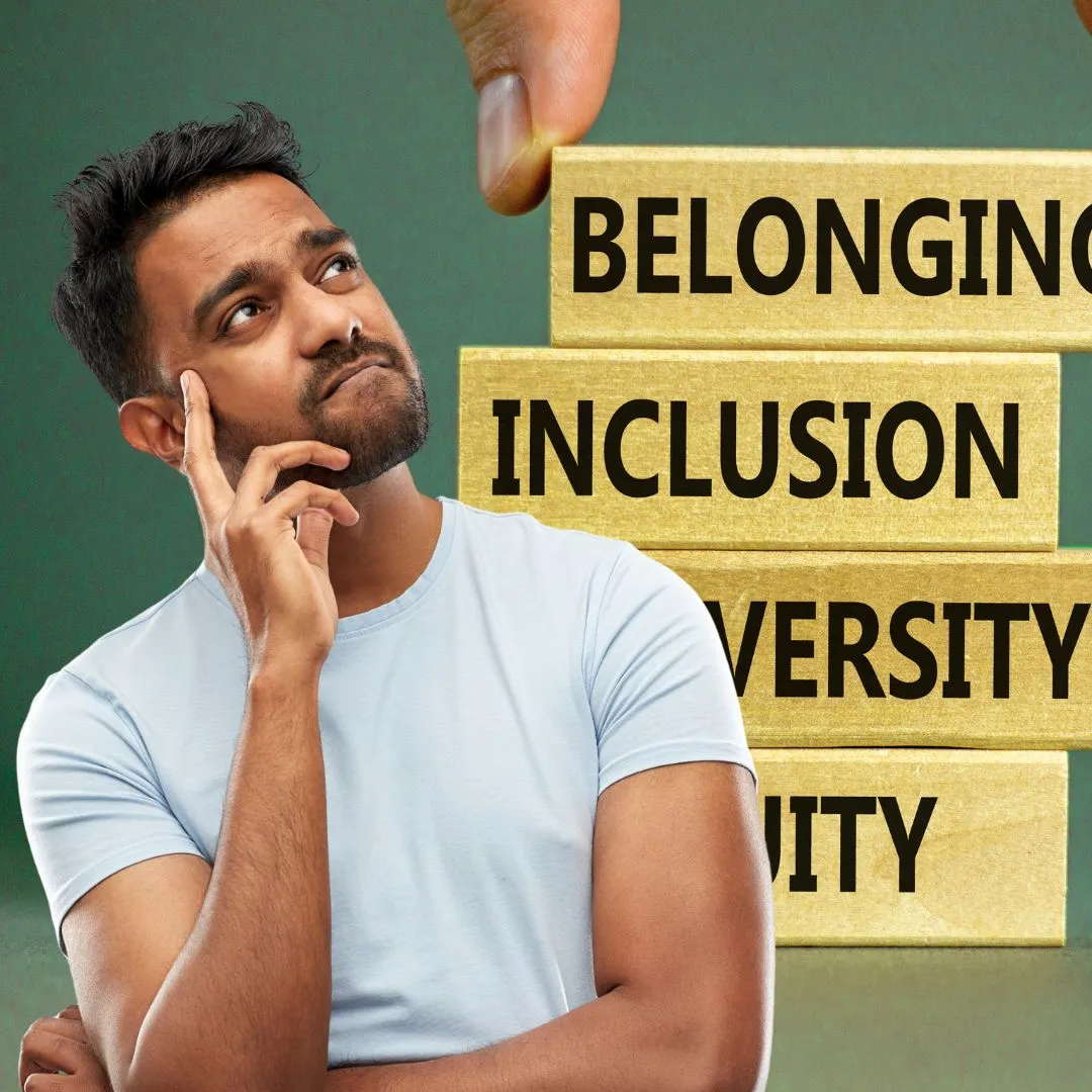 A man standing in front of a sign that says belonging, inclusion,.