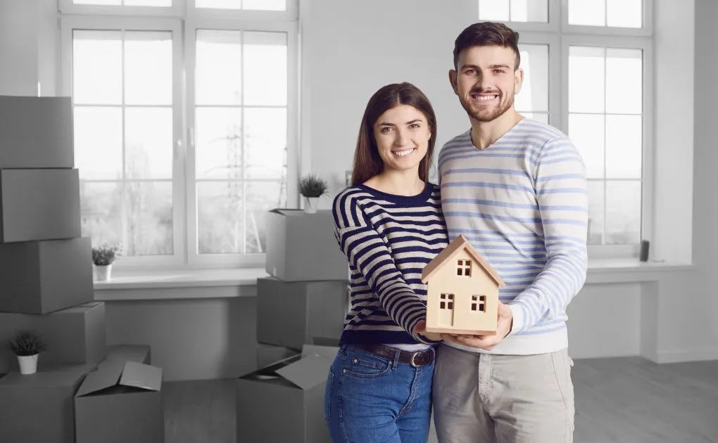 couple holding a house