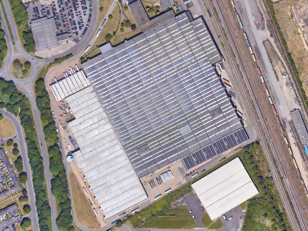 Aerial view of exterior of large warehouse.