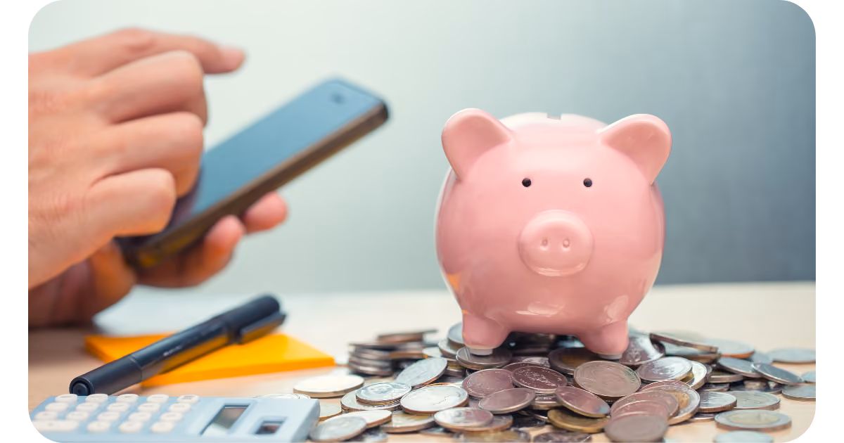 Piggy bank with coins and a moble phone