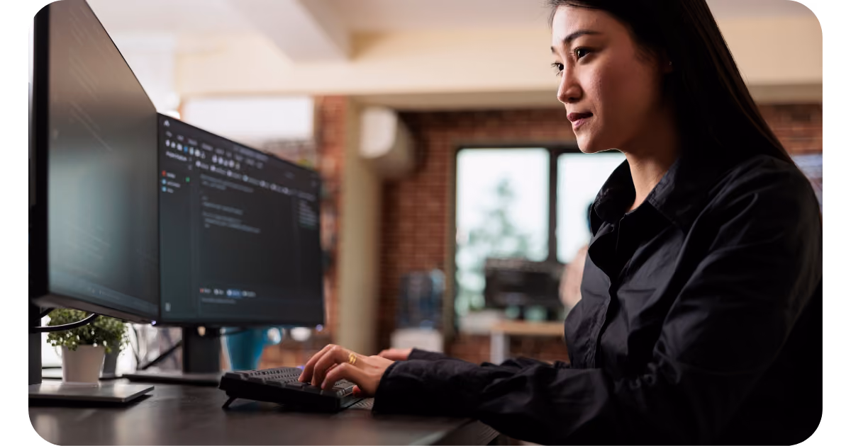 A person working on a computerin front of a monitor