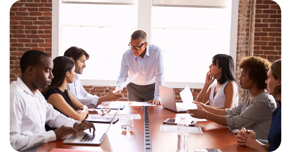 A group of people sitting around a conference table.