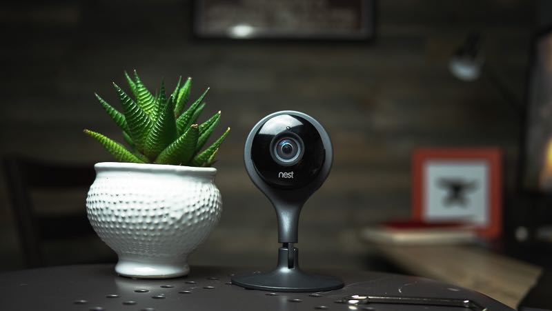 A baby webcam stylish, sleek, dark grey resting on a tabletop