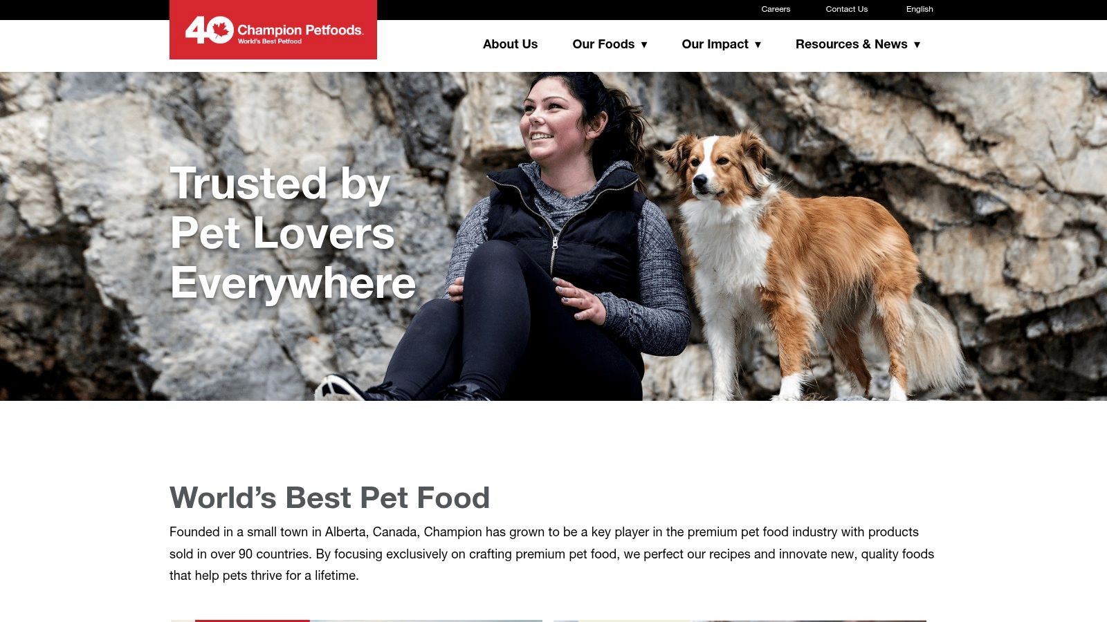 A person happily holding their dog, representing the end consumer for Champion Petfoods products.