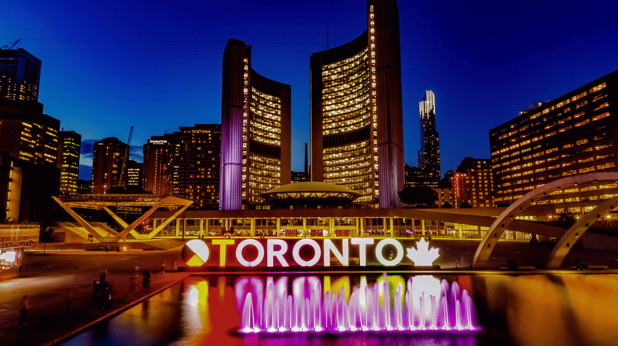 Toronto City Hall at night with vibrant IT services and CloudOrbis cybersecurity solutions